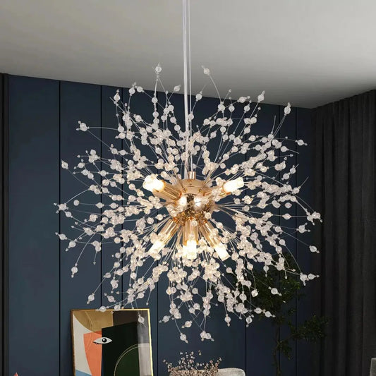 Decorative chandelier with floral-like design against a dark blue wall