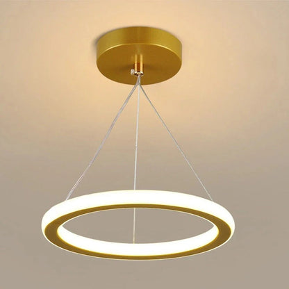 Gold-pendant-light-with-a-circular-design-on-a-neutral-background