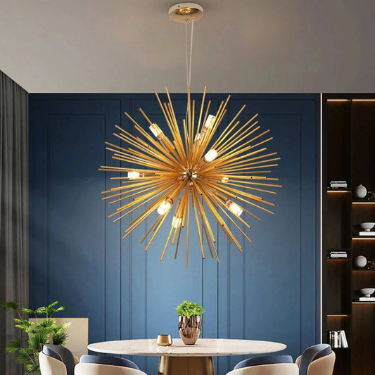 Gold starburst chandelier hanging above a dining table with a blue wall background