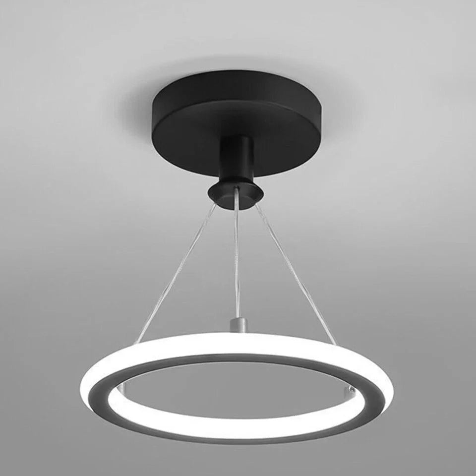 Modern-black-pendant-light-with-circular-design-on-a-gray-background