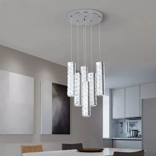 Modern chandelier hanging in a kitchen with a neutral color scheme