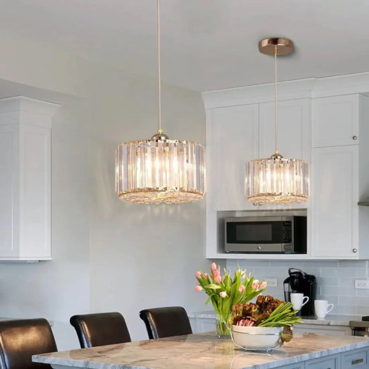 Modern kitchen with two hanging pendant lights, a dining table, and kitchen appliances
