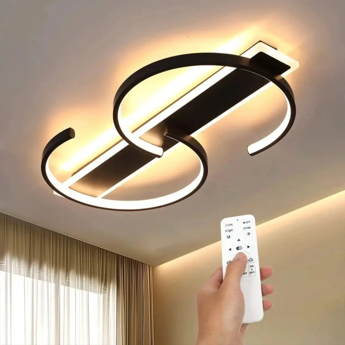 Modern S shape ceiling light fixture with a hand holding a remote control in a room setting