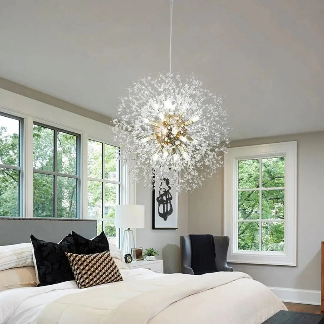 Modern bedroom with a large chandelier, bed, and windows