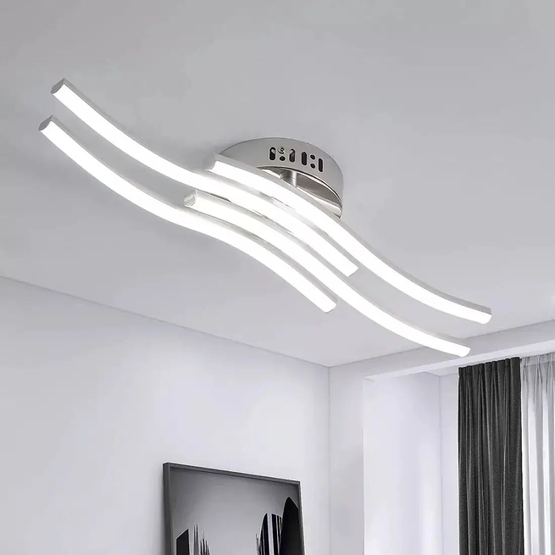 Modern ceiling light fixture in a room with white walls and a window