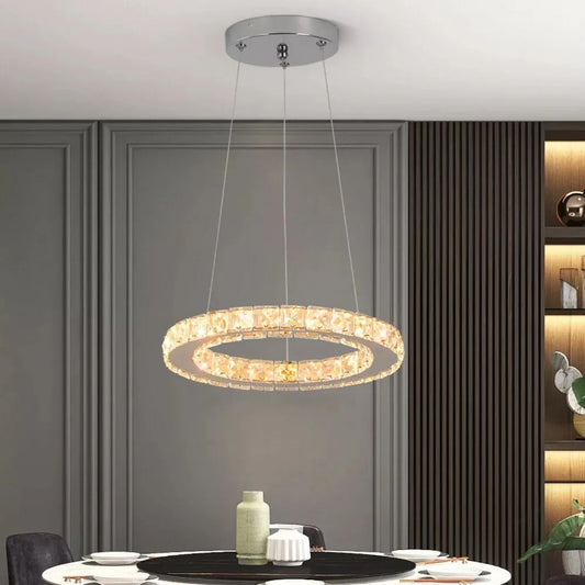 Modern pendant light hanging above a dining table with a neutral background