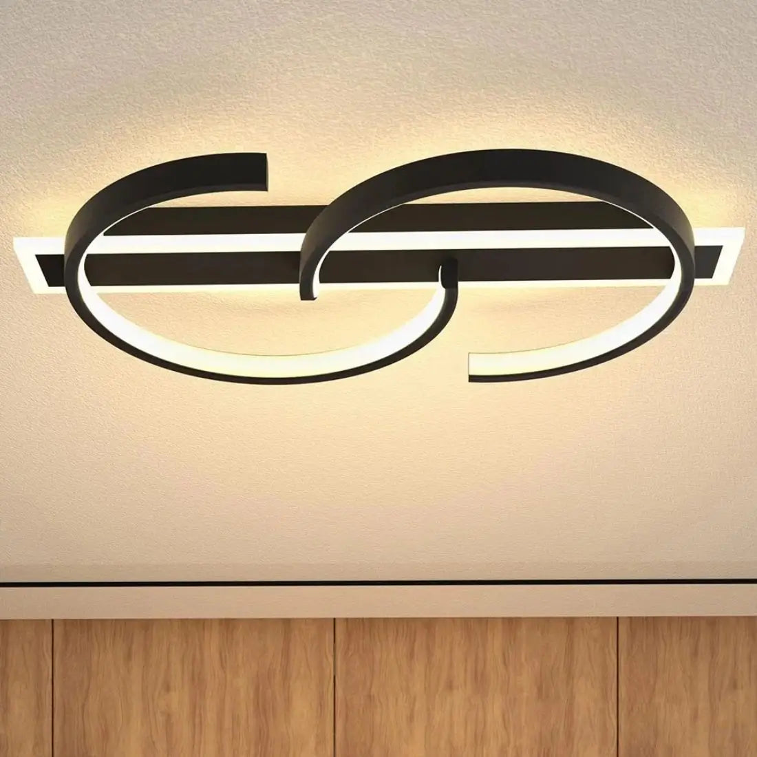 Modern wall-mounted S shape light fixture with black and white design on a neutral background